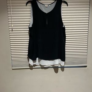 Ecru sleeveless blouse.